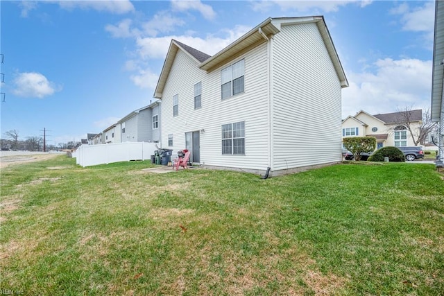 back of house with a lawn