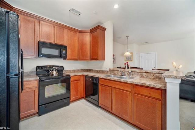 kitchen with sink, black appliances, pendant lighting, and kitchen peninsula