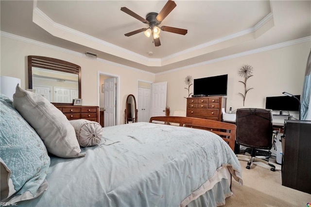 carpeted bedroom featuring ceiling fan, a tray ceiling, and crown molding