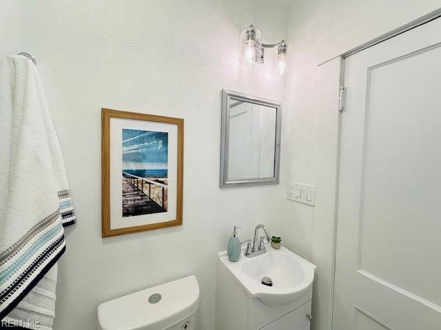 bathroom with toilet and vanity