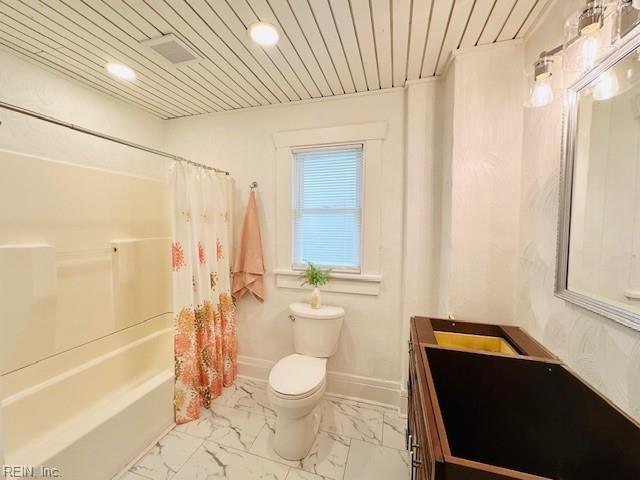 full bathroom with toilet, vanity, and shower / bath combination with curtain