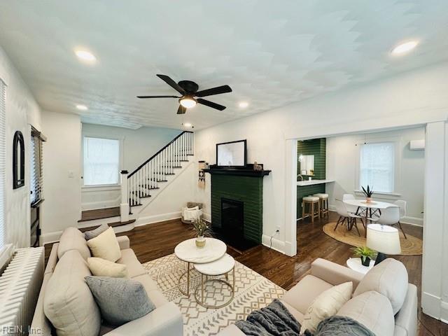 living room with ceiling fan and dark hardwood / wood-style floors