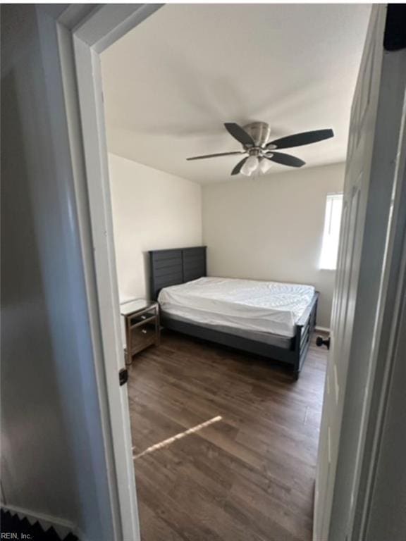 bedroom with ceiling fan and dark hardwood / wood-style flooring