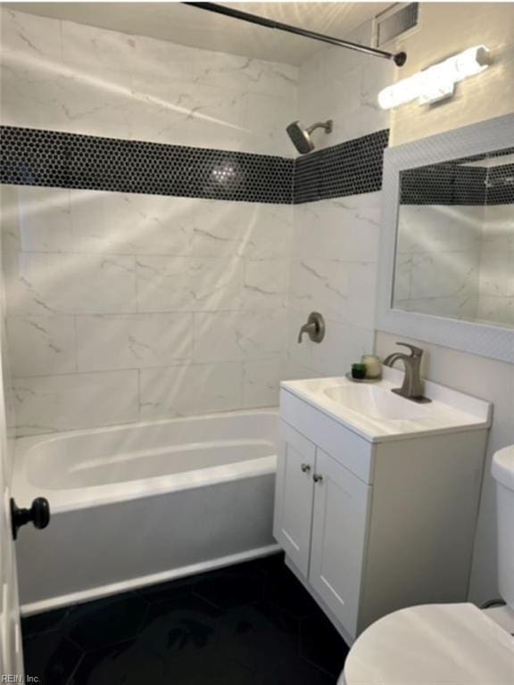 full bathroom with vanity, toilet, and tiled shower / bath combo