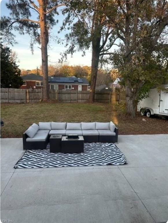 patio terrace at dusk featuring an outdoor living space