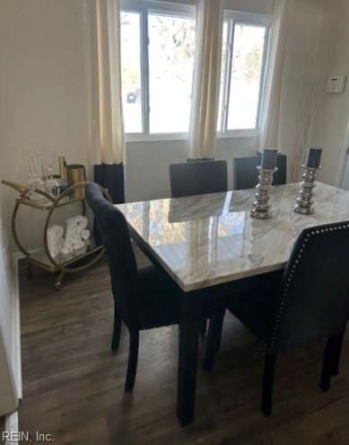 dining space with dark wood-type flooring