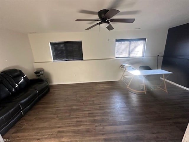 living room with ceiling fan and dark hardwood / wood-style floors