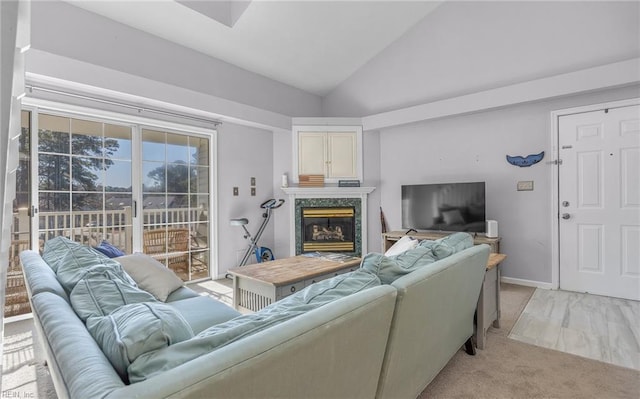 carpeted living room featuring a high end fireplace and high vaulted ceiling