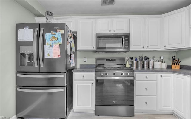 kitchen with stainless steel appliances and white cabinetry