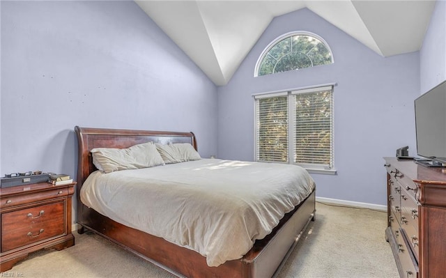 bedroom featuring light carpet and vaulted ceiling