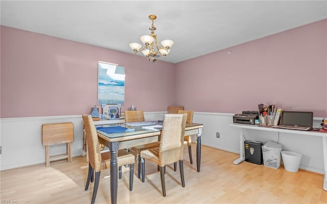 dining space featuring an inviting chandelier and light hardwood / wood-style floors