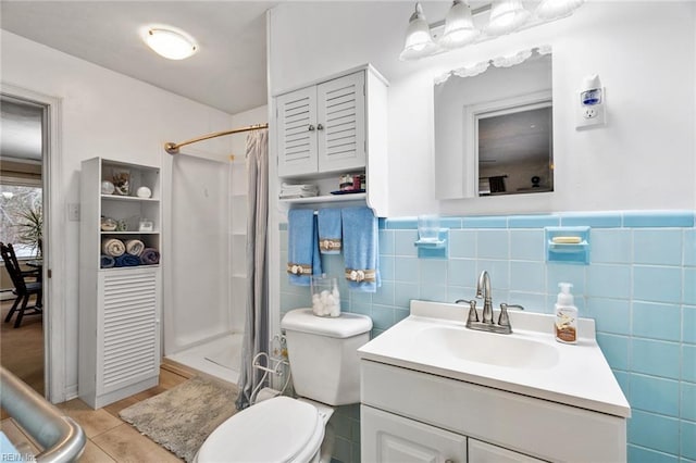 bathroom with tile patterned floors, tile walls, toilet, walk in shower, and vanity