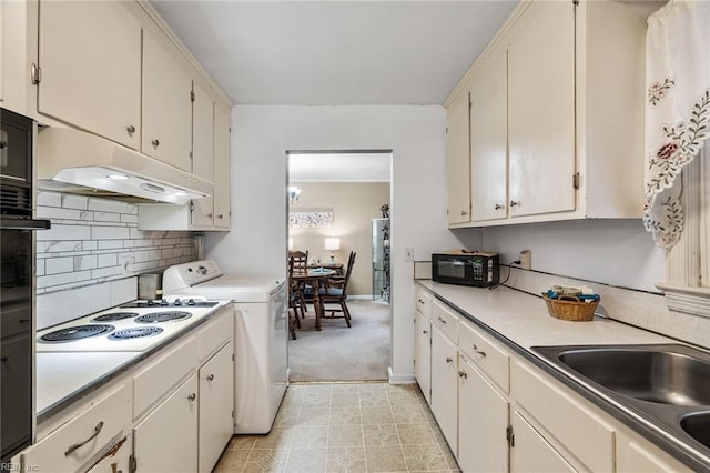 kitchen featuring white cabinets and washer / dryer