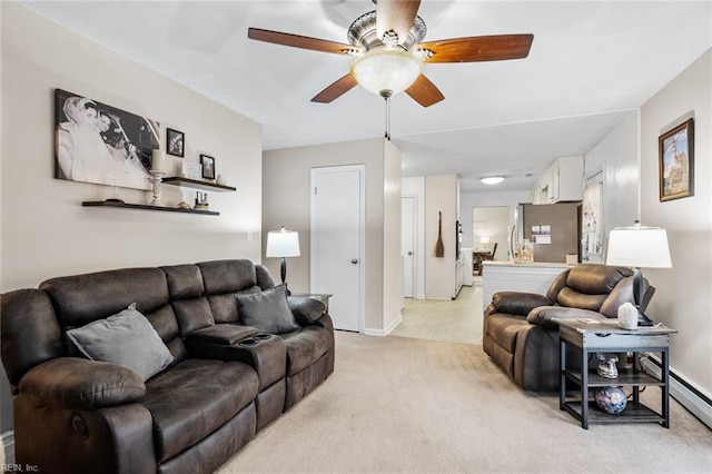 living room with ceiling fan, light colored carpet, and a baseboard radiator