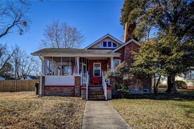 view of front of house featuring a front yard and a sunroom