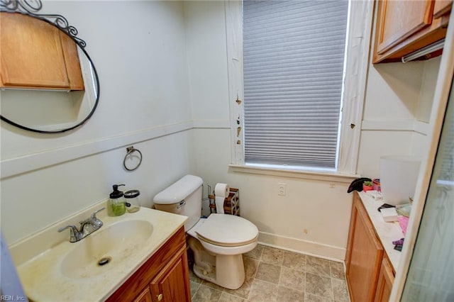 bathroom featuring toilet and vanity