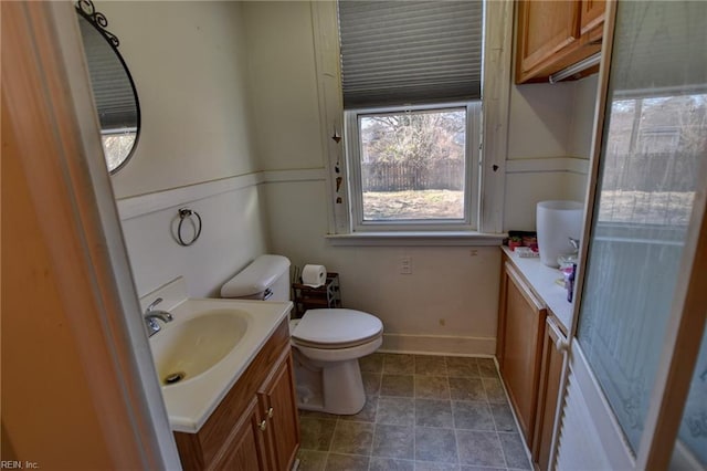 bathroom featuring toilet and vanity