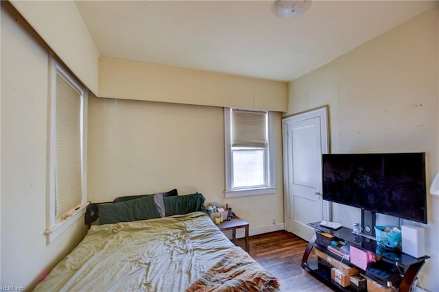 bedroom with dark wood-type flooring