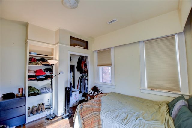 bedroom with a closet and hardwood / wood-style floors