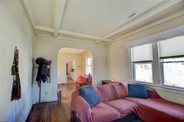 living room featuring dark hardwood / wood-style floors, beamed ceiling, coffered ceiling, and ornamental molding