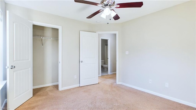 unfurnished bedroom with ceiling fan, light carpet, and a closet