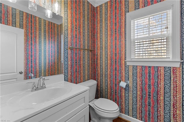 bathroom featuring toilet and vanity