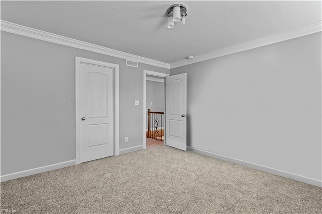 unfurnished bedroom with crown molding and carpet flooring