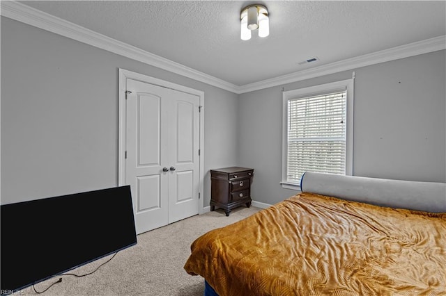 carpeted bedroom with crown molding and a textured ceiling