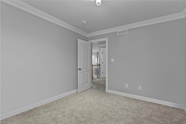 carpeted empty room with crown molding