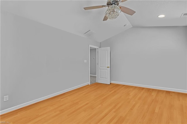 empty room featuring ceiling fan, hardwood / wood-style floors, and vaulted ceiling