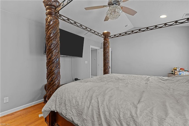 bedroom featuring ceiling fan, wood-type flooring, and lofted ceiling