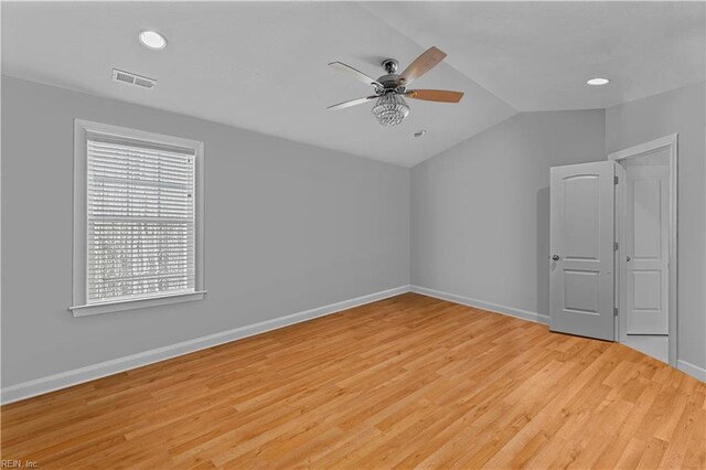 empty room featuring ceiling fan, light hardwood / wood-style flooring, and lofted ceiling