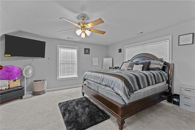 bedroom with ceiling fan and light carpet