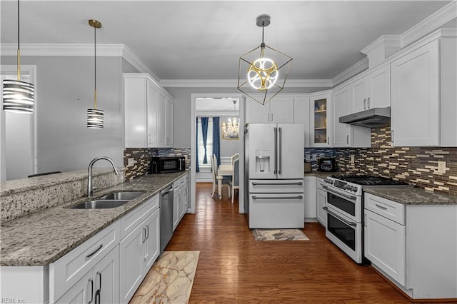 kitchen with sink, double oven range, white refrigerator with ice dispenser, and pendant lighting