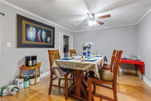 dining space featuring ceiling fan, wood-type flooring, and crown molding