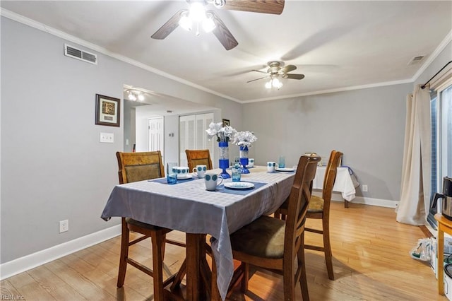 dining space featuring ceiling fan, ornamental molding, and light hardwood / wood-style floors