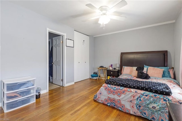 bedroom featuring ceiling fan, hardwood / wood-style floors, and ornamental molding