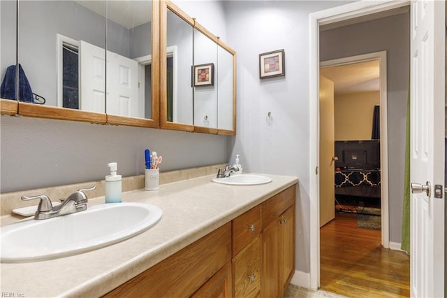 bathroom with hardwood / wood-style floors and vanity