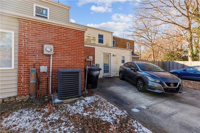 view of side of home with central AC unit