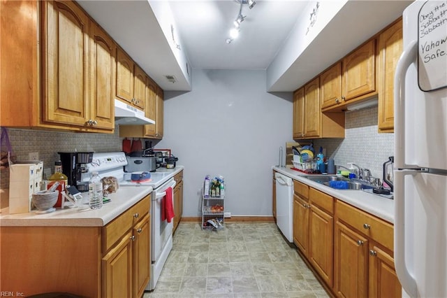 kitchen with decorative backsplash, sink, and white appliances