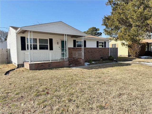 view of front of property with covered porch and a front lawn