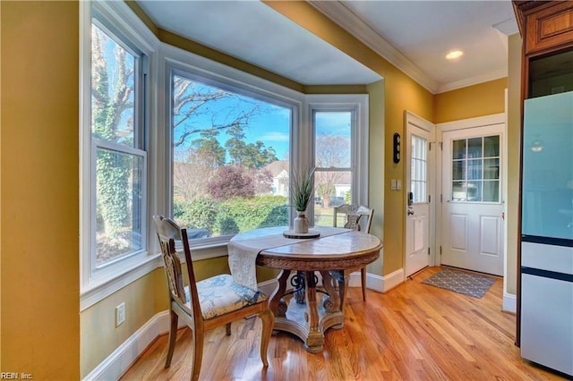 interior space featuring ornamental molding and light hardwood / wood-style floors