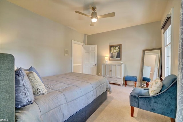 bedroom featuring light carpet and ceiling fan