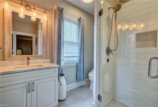 bathroom featuring vanity, an enclosed shower, and toilet