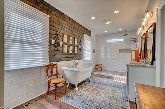 living area with tile walls and hardwood / wood-style flooring