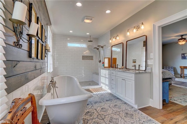 bathroom with vanity, hardwood / wood-style floors, shower with separate bathtub, and ceiling fan