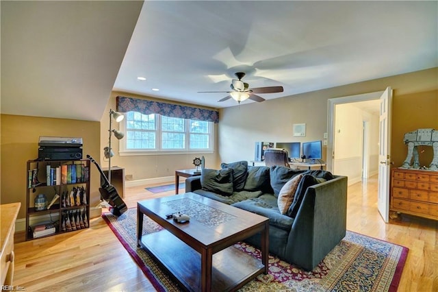 living room with ceiling fan and light hardwood / wood-style floors