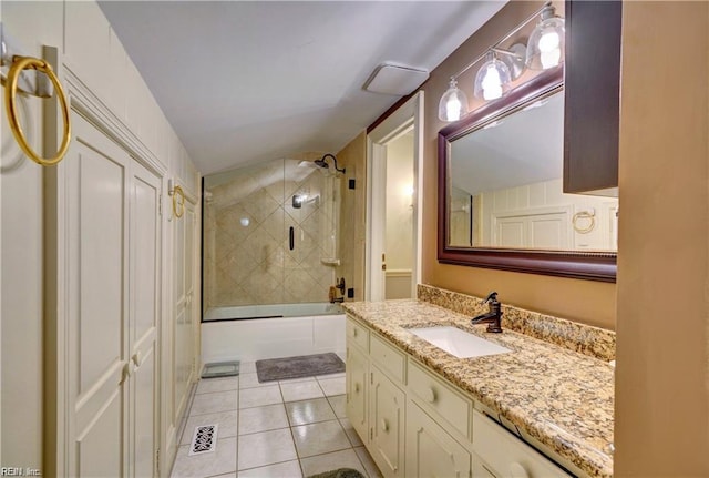 bathroom with tile patterned flooring, bath / shower combo with glass door, and vanity