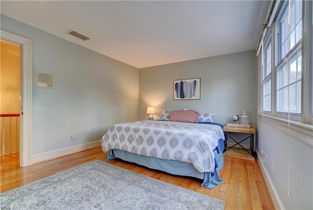 bedroom with hardwood / wood-style flooring