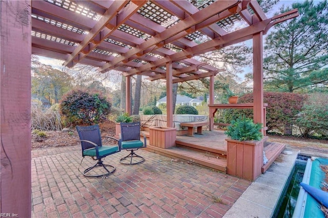 view of patio featuring a wooden deck, a pergola, and a jacuzzi